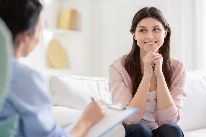 Smiling woman talking to wellness coach 